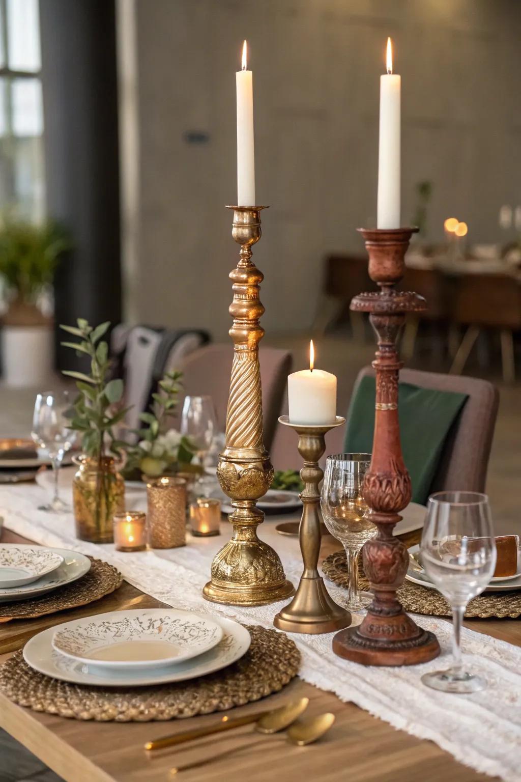 An eclectic centerpiece featuring mixed candlestick holders in varying styles and heights.