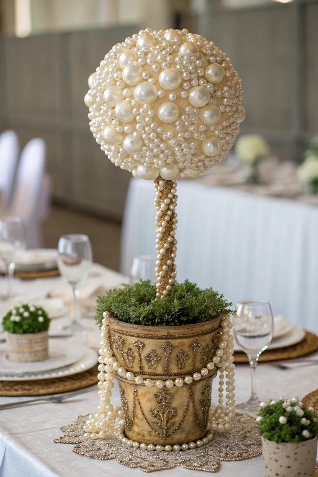 An elegant pearl topiary adding sophistication to a festive dining setting.