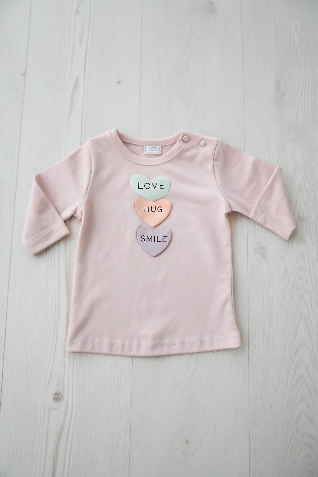 Dress your little one in sweet minimalism with our charming sweetheart candy shirt, perfect for a Valentine's Day full of love and smiles!