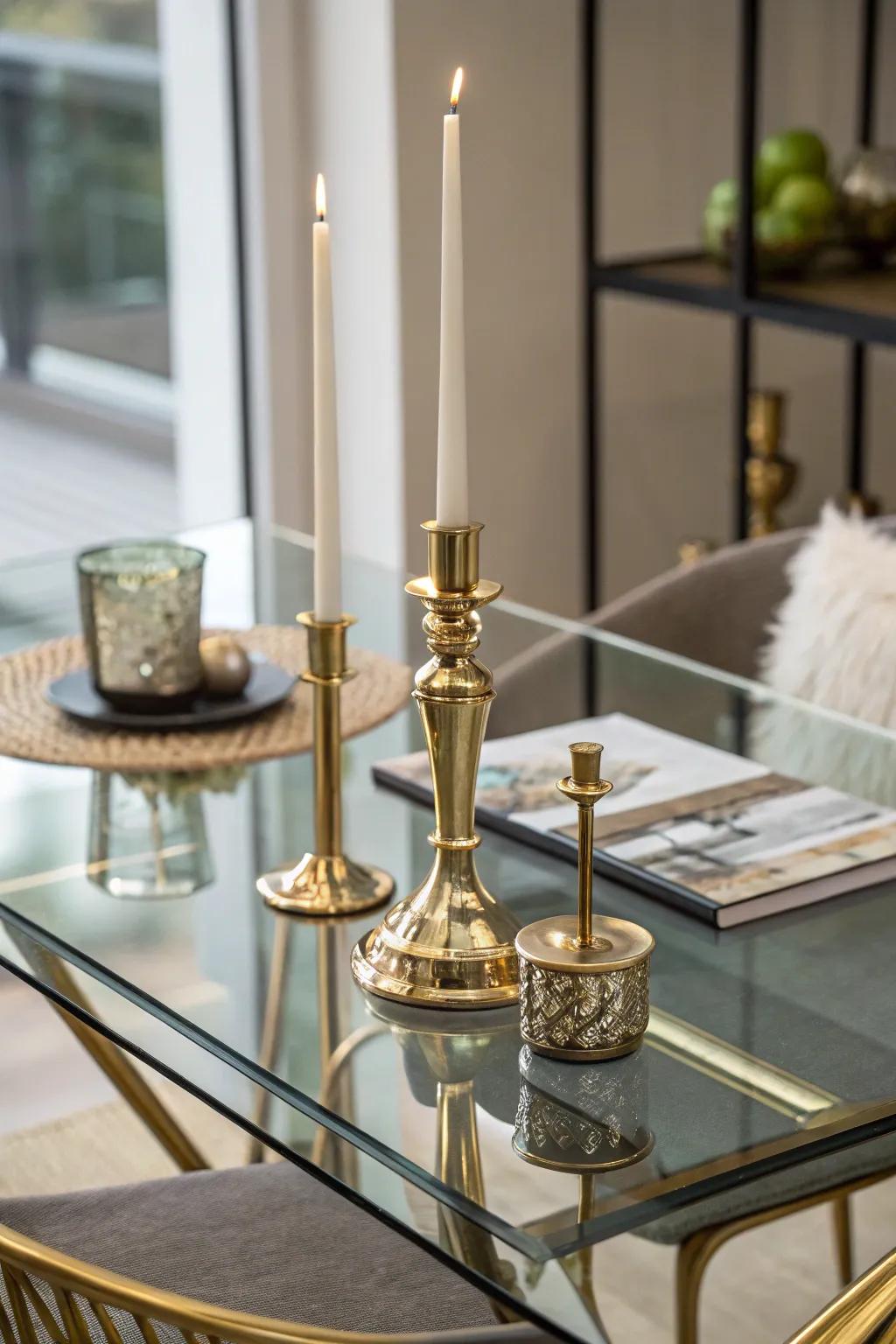 Brass candlesticks adding a touch of glamour to a glass dining table.