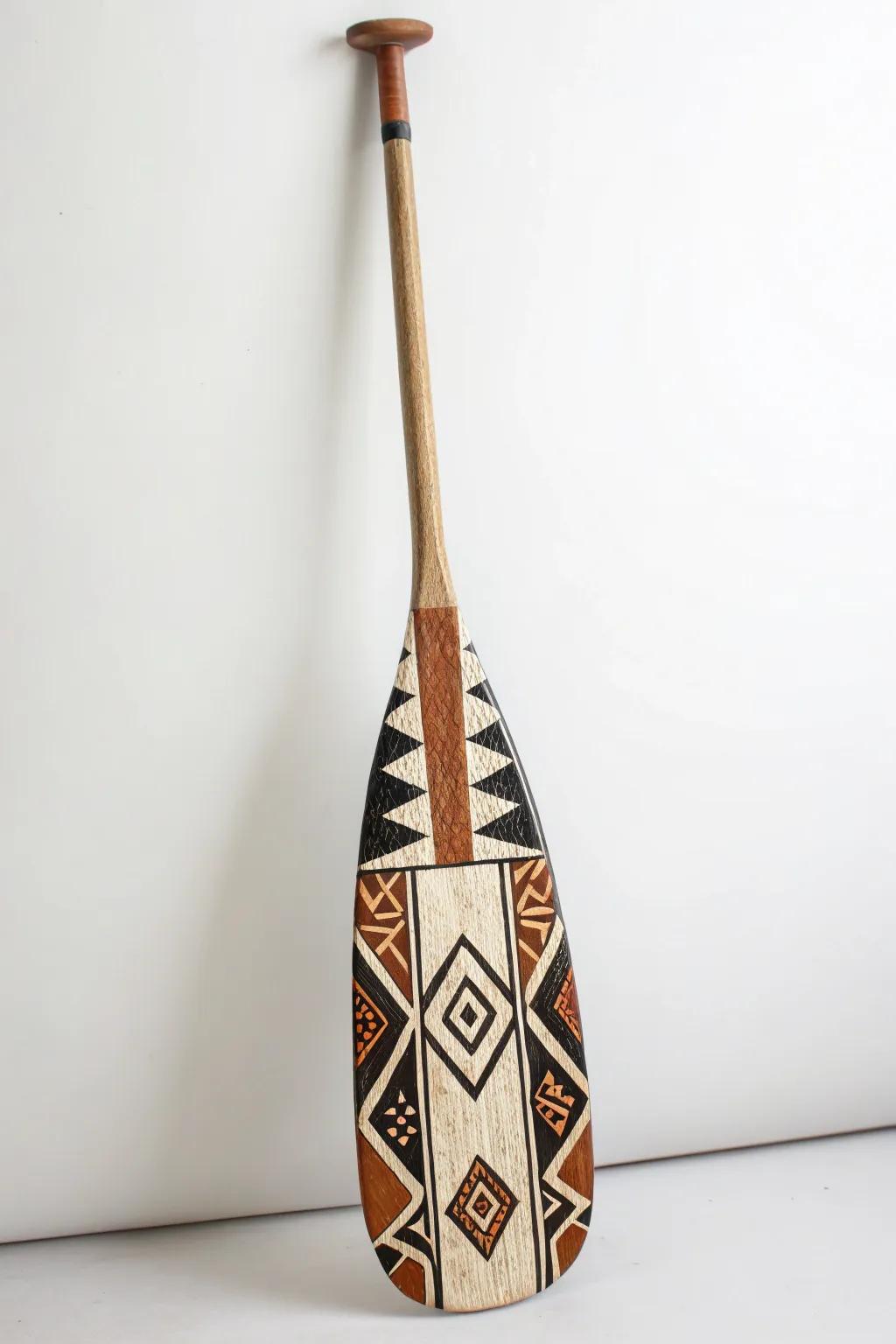 Embrace global artistry with this beautifully crafted paddle, showcasing the timeless elegance of traditional African mud cloth designs.