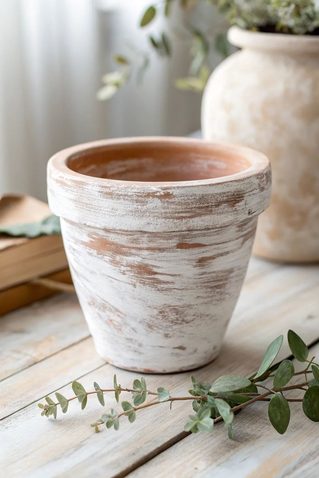 Clay pot craft ideas with a whitewashed terracotta pot showing dry-brushed white over orange-brown clay