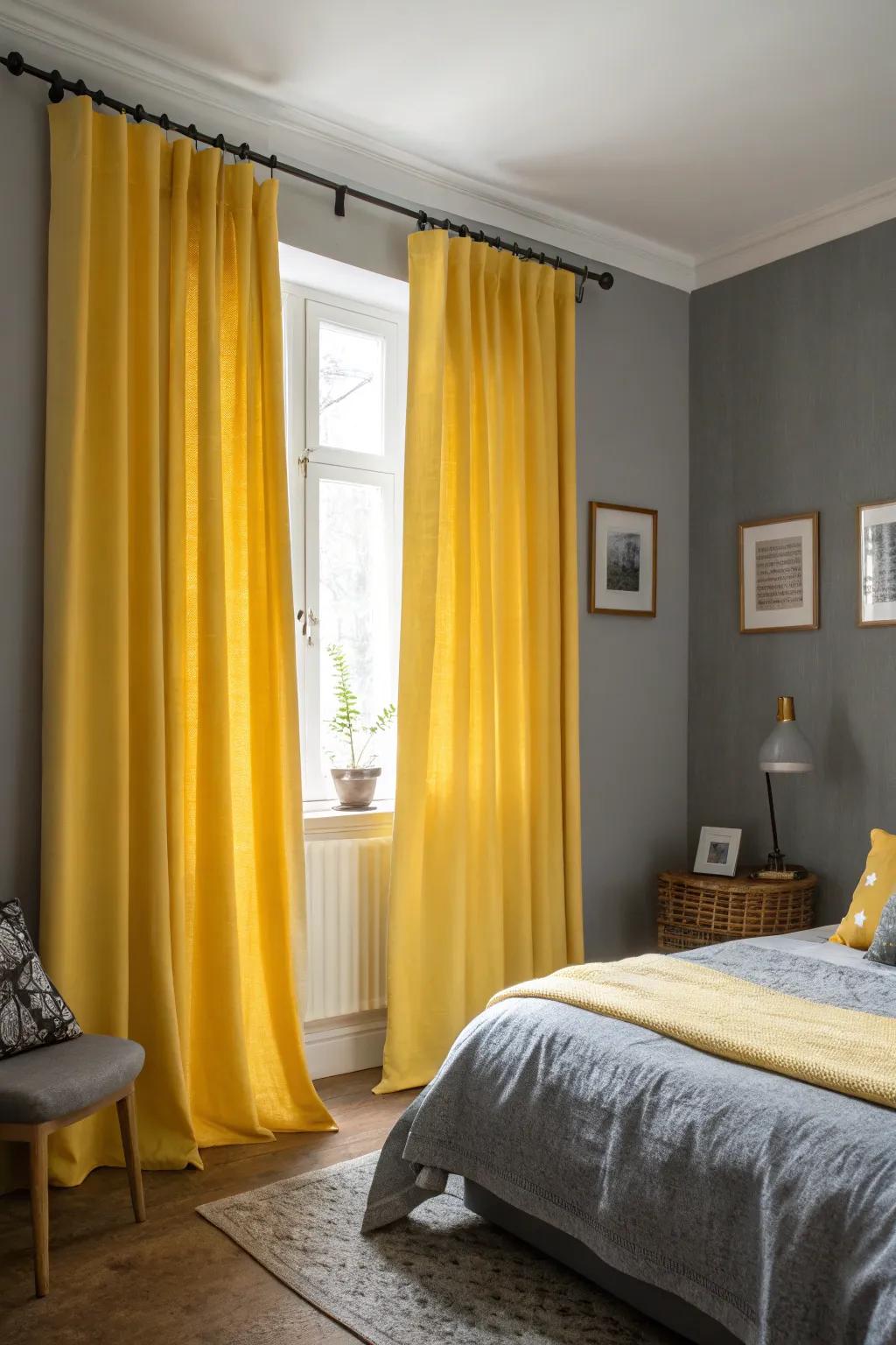 Yellow curtains add a vibrant touch to a room with grey walls.