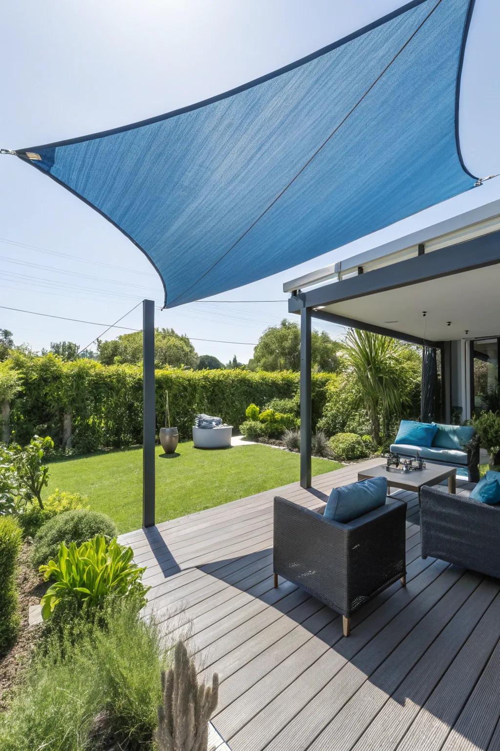 A shade sail offers privacy and sun protection on this modern deck.